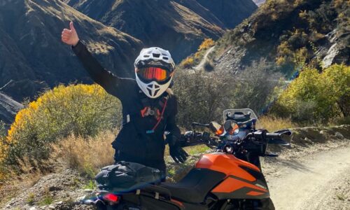 A female motorcyclist navigating a stunning off-road trail in Queenstown, part of the GOAT experience – an exclusive motorcycle tour for women led by experienced riders and supported by expert guides.