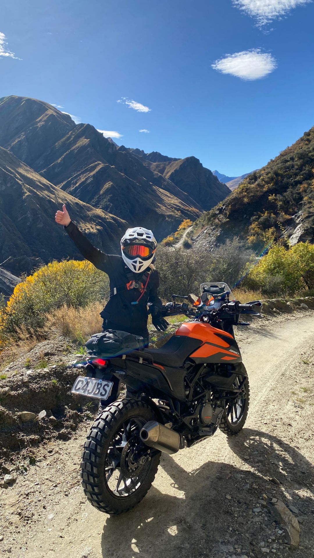 A female motorcyclist navigating a stunning off-road trail in Queenstown, part of the GOAT experience – an exclusive motorcycle tour for women led by experienced riders and supported by expert guides.